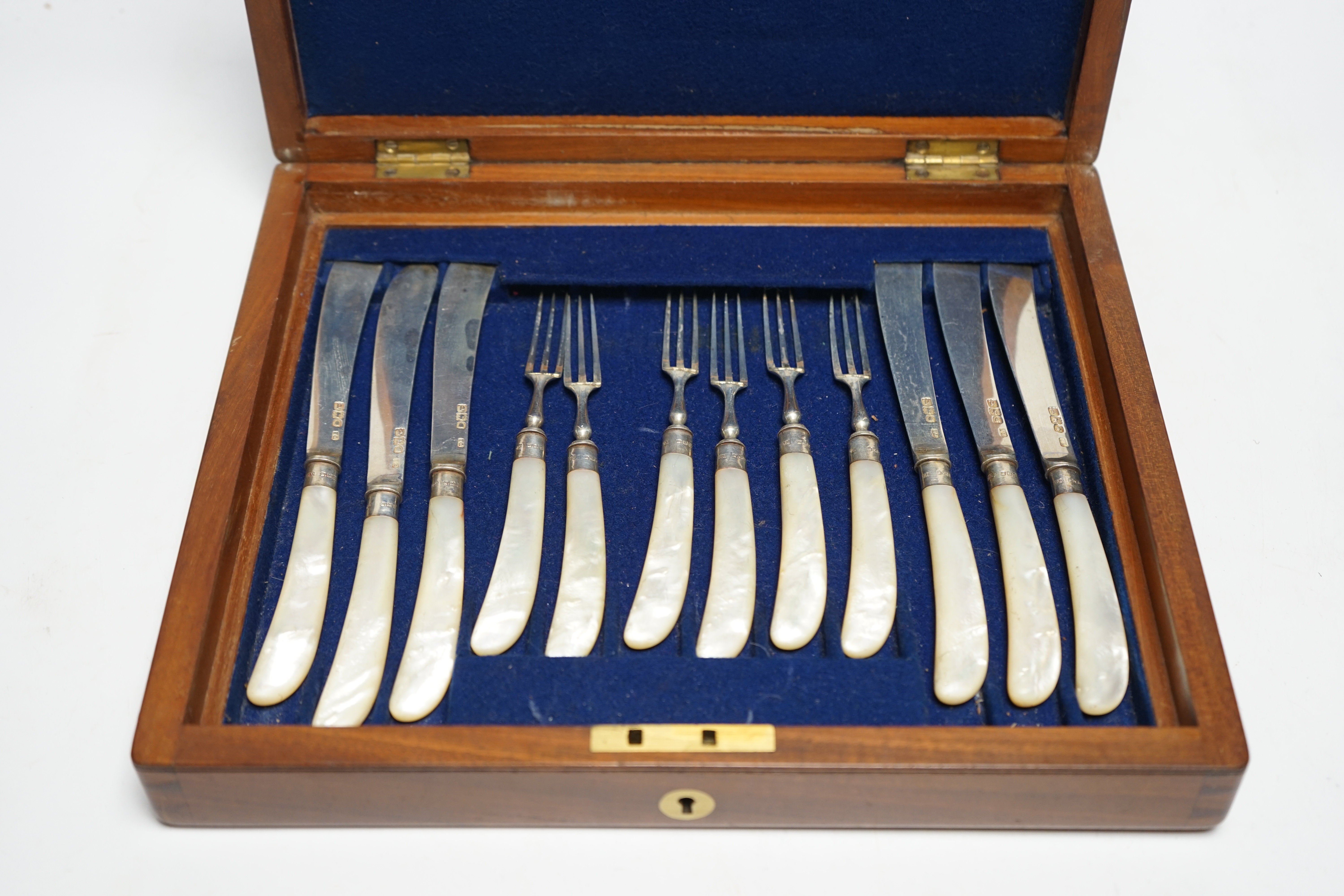 A set of twelve pairs of late Victorian mother of pearl pistol handled silver dessert eaters, by Levesley Brothers, London, 1899, in associated case. Condition - poor